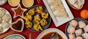 Lunar New Year festival table over red background. Traditional lunar new year food.