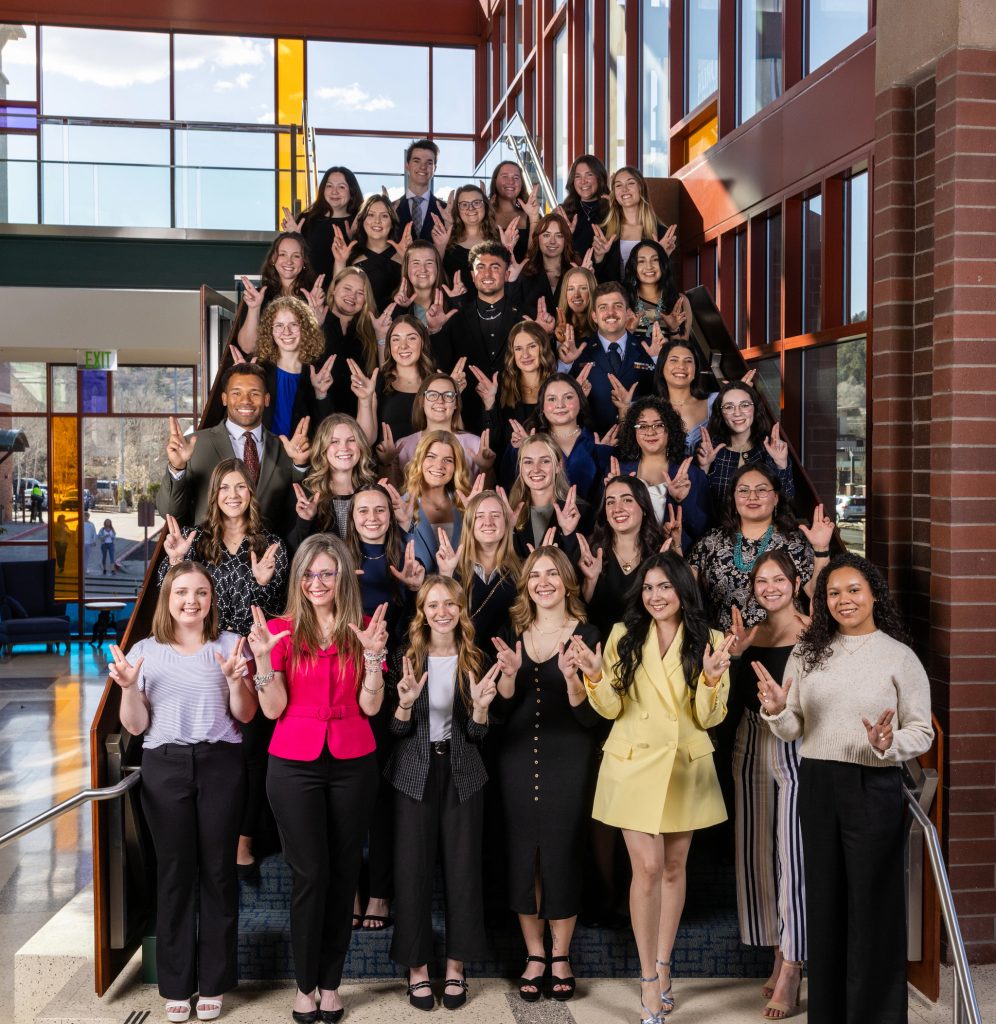 Winners of the Gold Axe, President's Prize and Distinguished Senior awards flash LJs on a staircase in the High Country Conference Center.