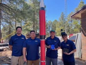Carson Pete, Joshua Wilson, Stonn Billy and Ryan Yazzie stand with their rocket.