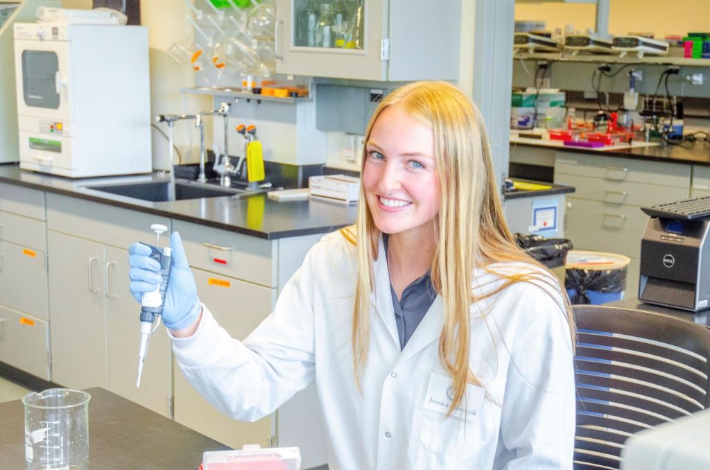 Jessica Marshall in a lab wearing a white lab coat.