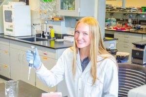 Jessica Marshall in a lab wearing a white lab coat.