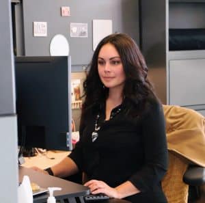 Melinda Smith sitting at her computer.