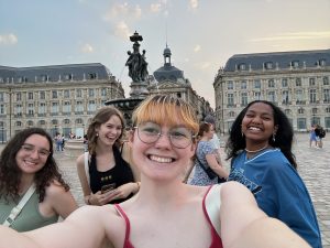 Senior Lydia Muentz takes a selfie with friends on the streets of Bordeaux, France.