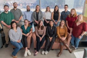 Professor Bridget Barker and 13 members of her lab pose for a photograph.