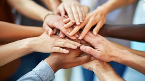 10 hands touching each other