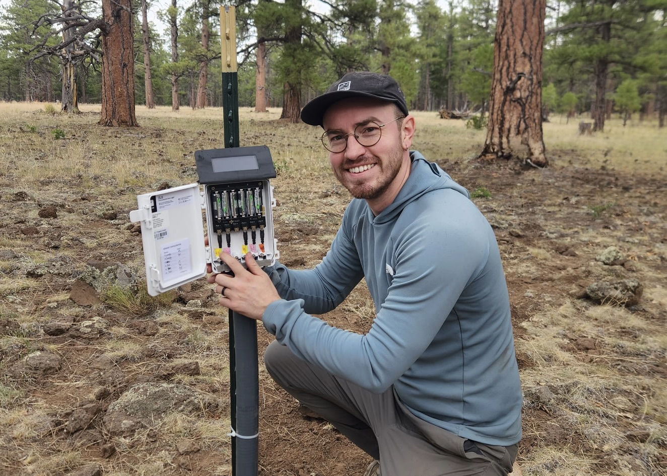 Caelum Mroczek posing with a water meter in Arizona