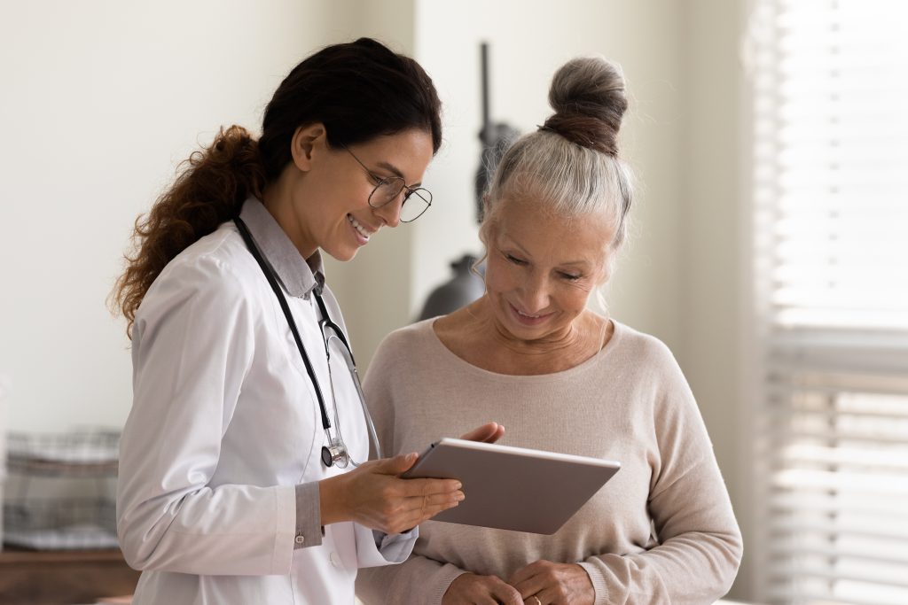 Female medical professional showing a chart to a woman