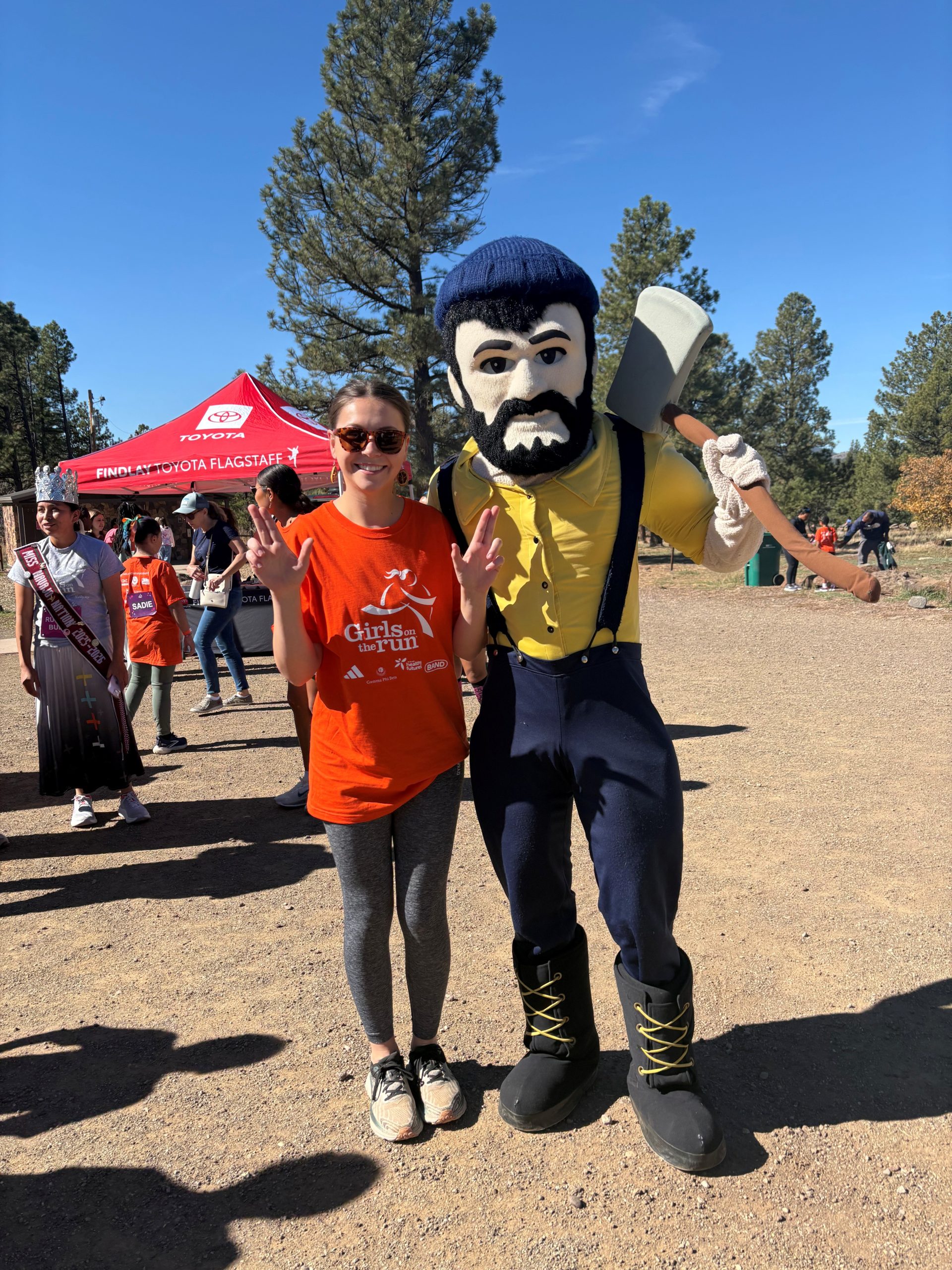 Rachel Kanyur stands with Louie the lumberjack at a volunteer event.