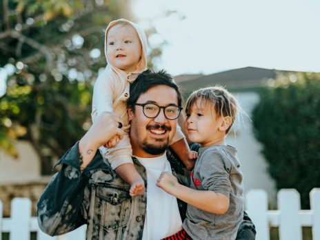 Image of father holding 2 children Photo by Nathan Dumlao on unsplash