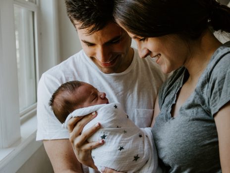 Image of parents holding a new baby Photo by Kelly Dikkema on unsplash
