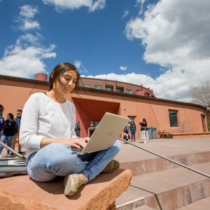 female student study with laptop outdoors