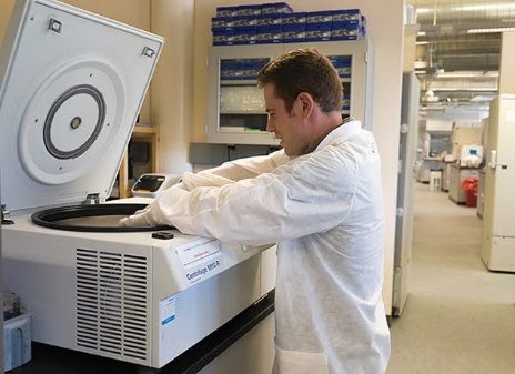 Image of Dan Sanchez, PhD, operating a centrifuge.