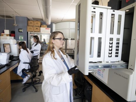 Person standing next to equipment in the Genetics Core Facility